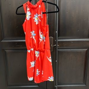 Love Zoe orange romper with blue flower design